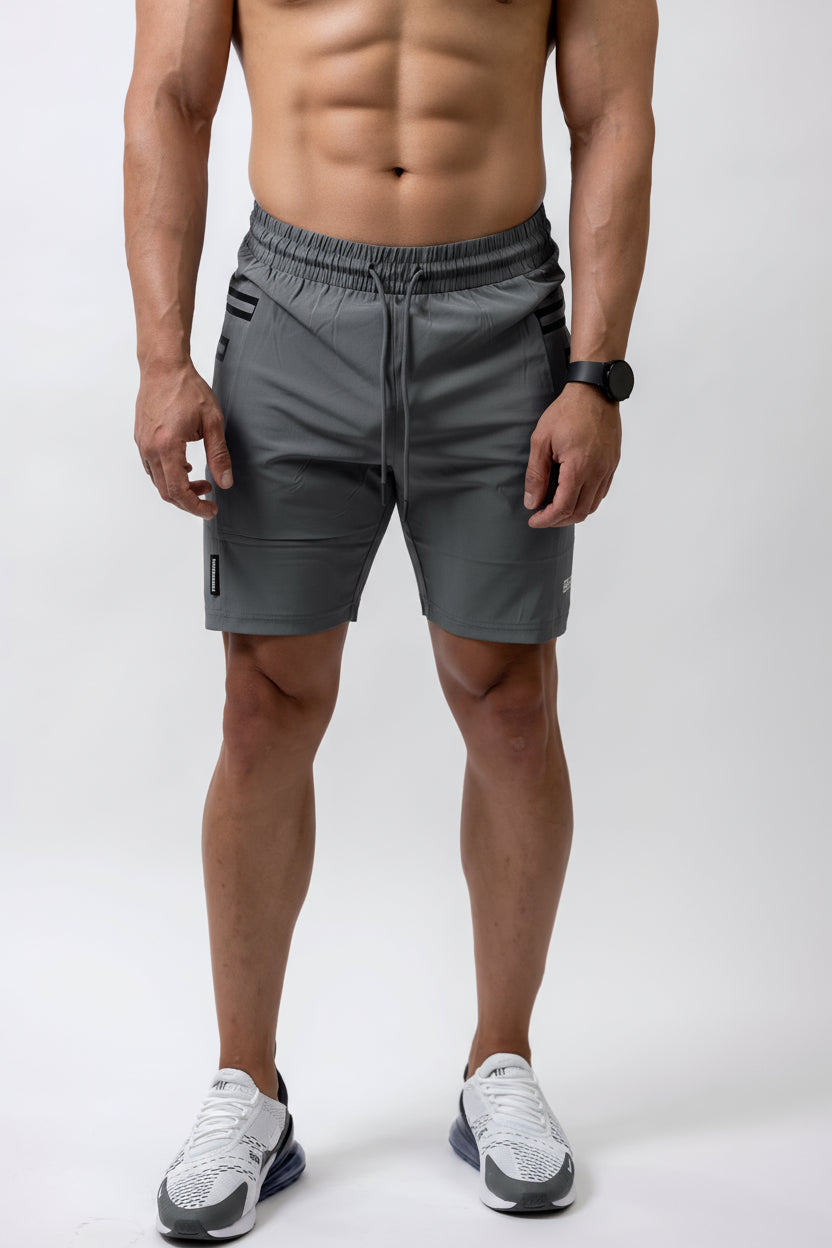 Man wearing gray athletic shorts on a white background