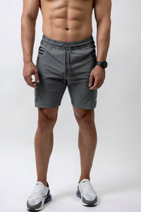 Man wearing gray athletic shorts on a white background