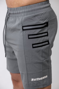 Gray shorts with black stripes and 'FitTrends' branding on a white background