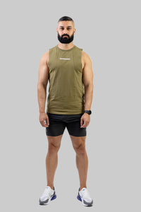 Man wearing an olive green tank top and black shorts on a white background