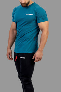 Person wearing a blue athletic shirt and black pants with a brand logo on a white background