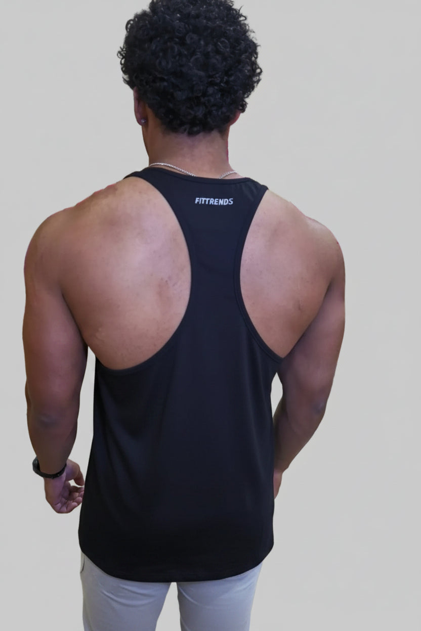 Person wearing a black tank top with 'FYTRENDIS' branding in a gym setting.