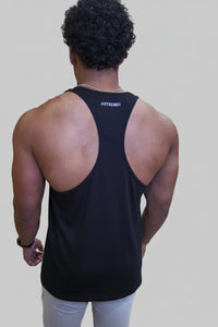 Person wearing a black tank top with 'FYTRENDIS' branding in a gym setting.