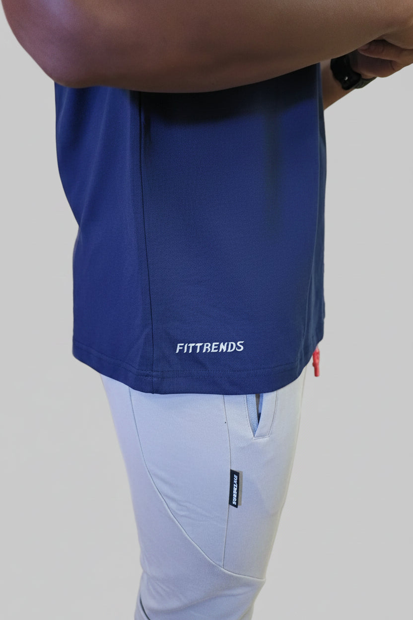 Person wearing blue shorts with 'FITTRENDS' branding in a gym setting.