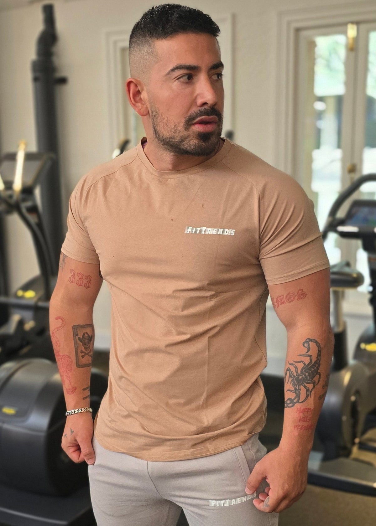Man posing in a room with exercise equipment
