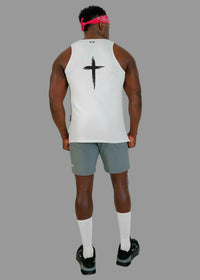 Person wearing a white tank top with a black cross design on the back, standing against a plain background.