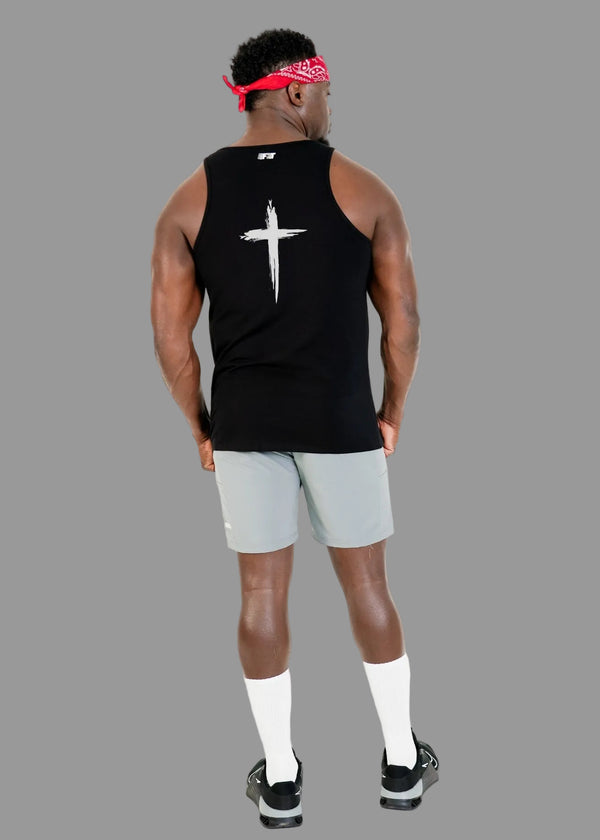 Person wearing a black tank top with a white cross design on the back, light gray shorts, and black sneakers against a white background.