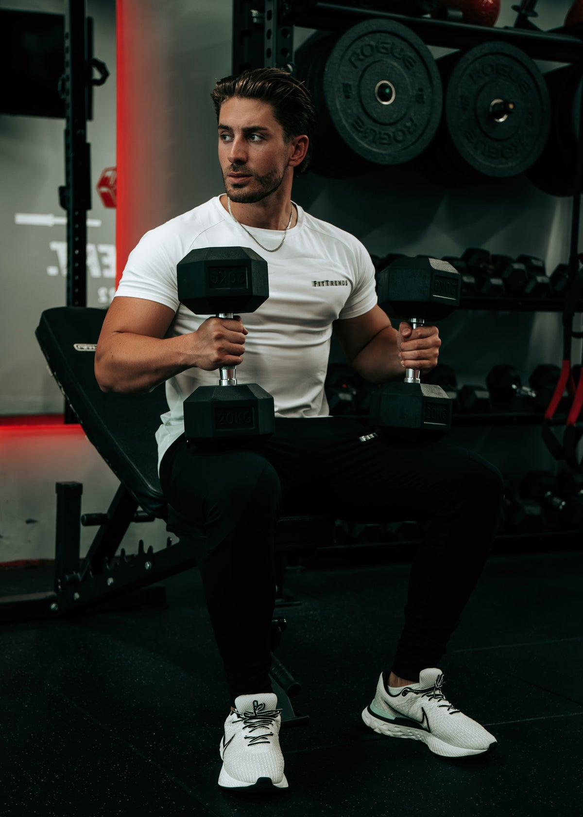 Man exercising with dumbbells in a gym setting