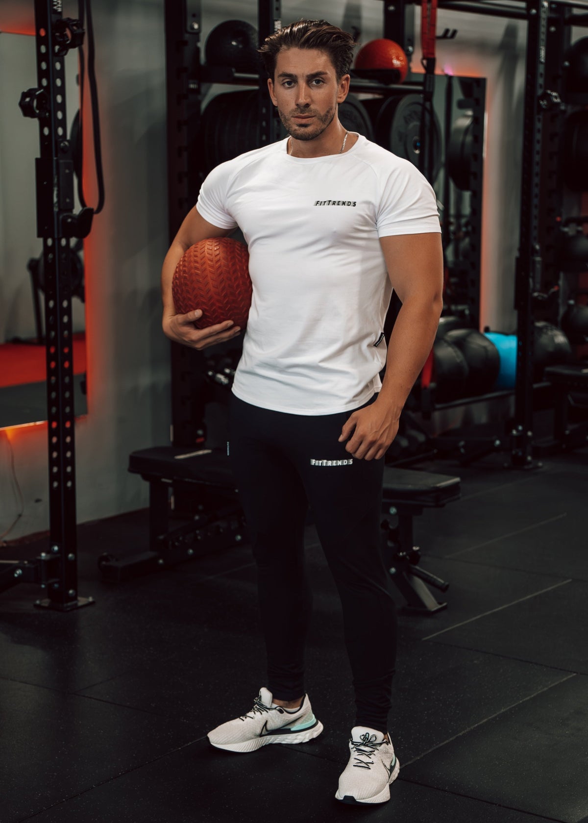 Man holding a basketball in a gym setting