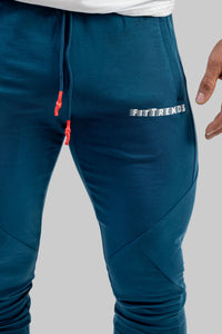 Blue jogger pants with a visible brand logo on a gray background