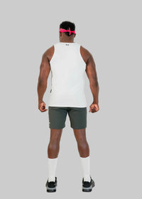 Person wearing a white tank top and green shorts on a white background