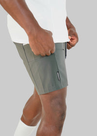Gray shorts worn by a person on a white background