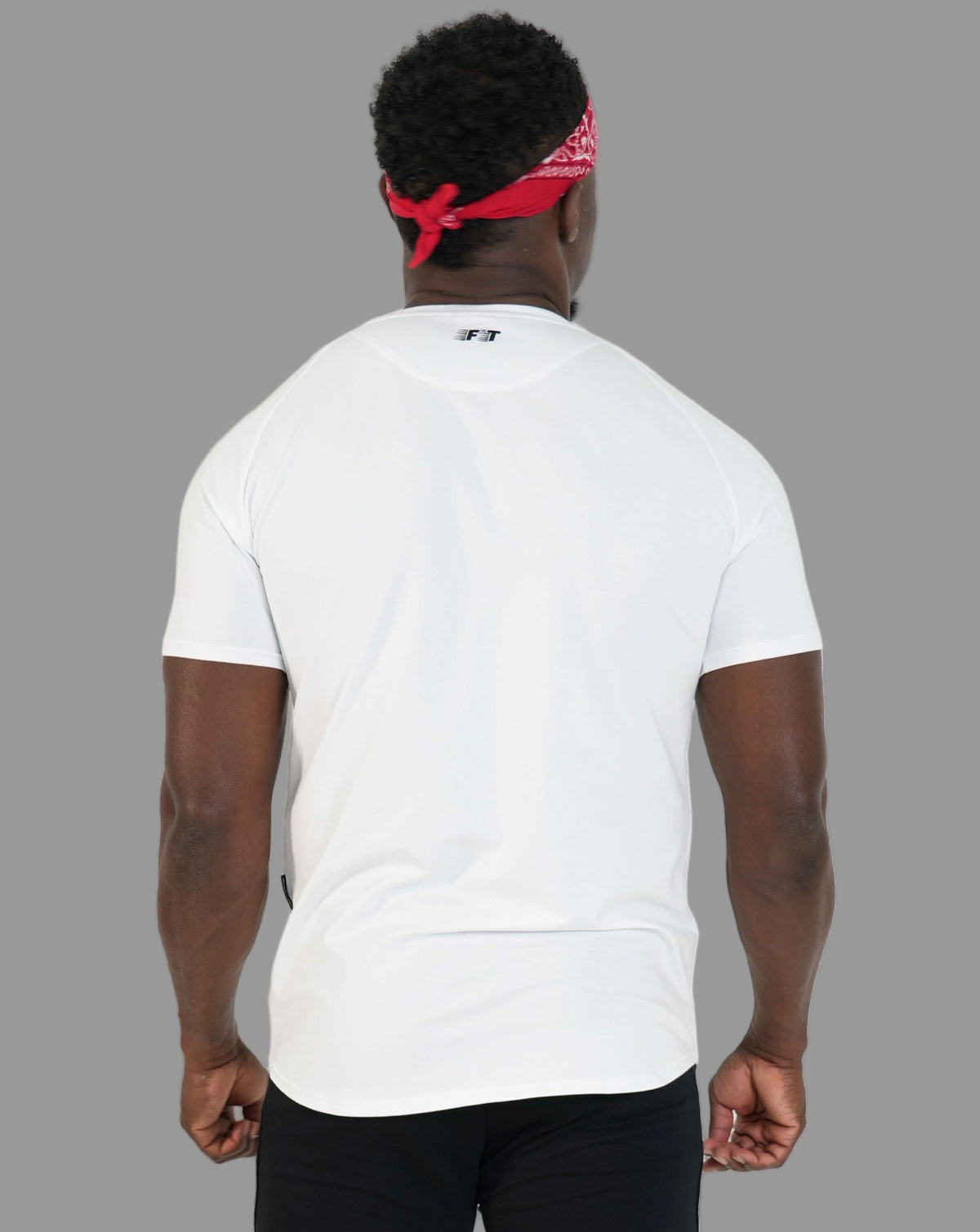 Person wearing a white t-shirt and black pants with a red bandana on a white background