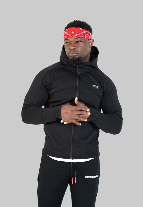 Man wearing a black hoodie and pants with a red bandana on a white background