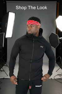 Man wearing a black hoodie and black pants with a red bandana on a white background