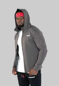 Man wearing a gray hoodie with a brand logo on a white background