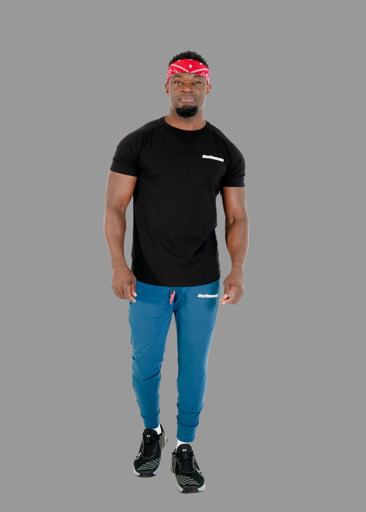 Man wearing a black t-shirt and blue pants on a white background