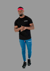 Man wearing a black t-shirt, blue pants, and a red headband with a brand logo on a white background