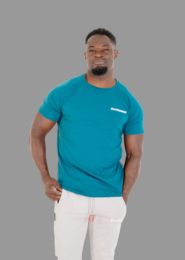 Man wearing a blue t-shirt with a logo on a white background