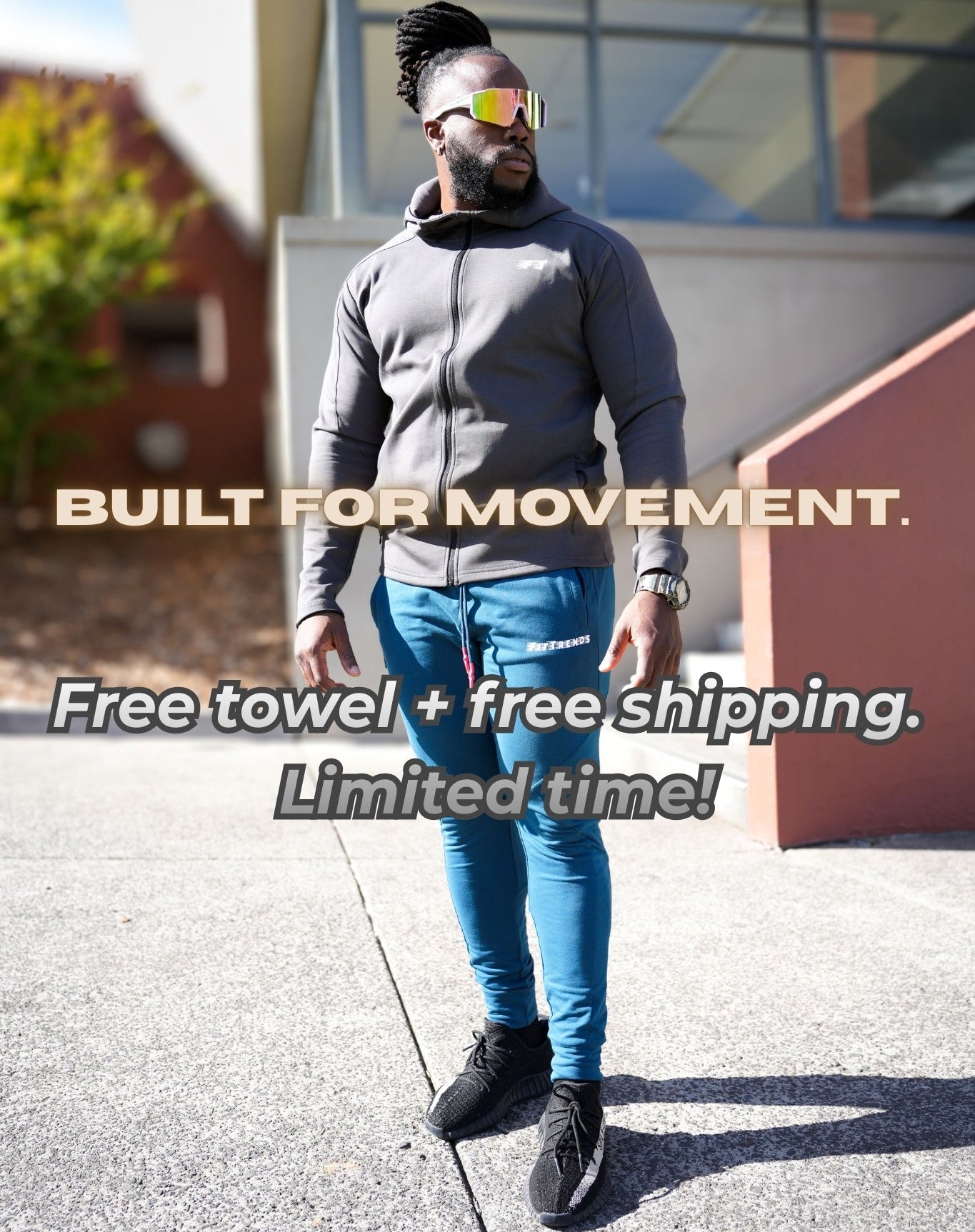 Person wearing a gray sweatshirt and blue jeans standing outdoors with promotional text overlay.