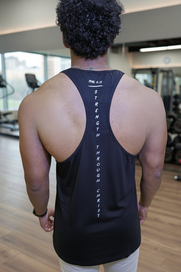 Person wearing a black tank top with text in a gym setting
