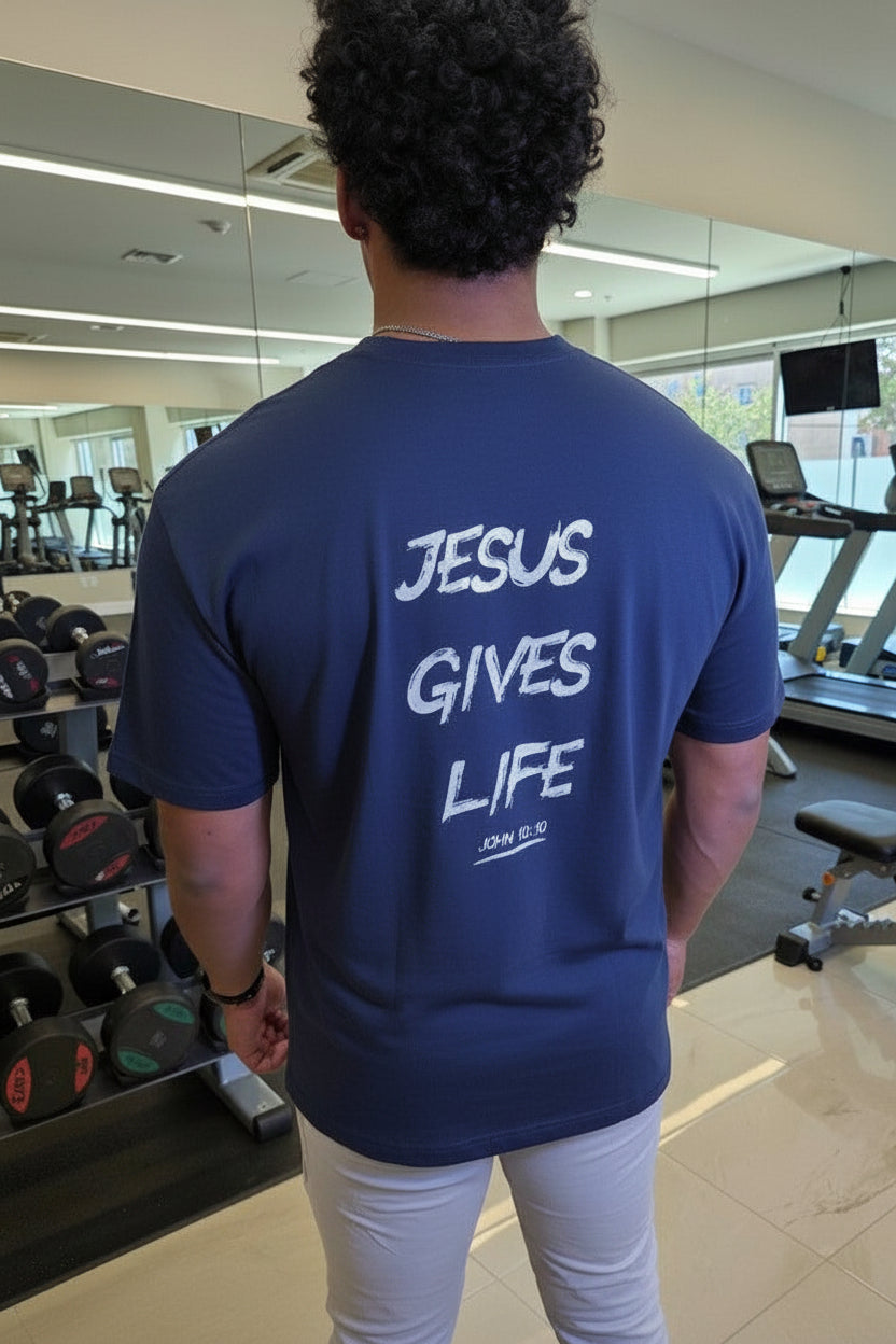 Person wearing a blue t-shirt with 'Jesus Gives Life' text in a gym setting